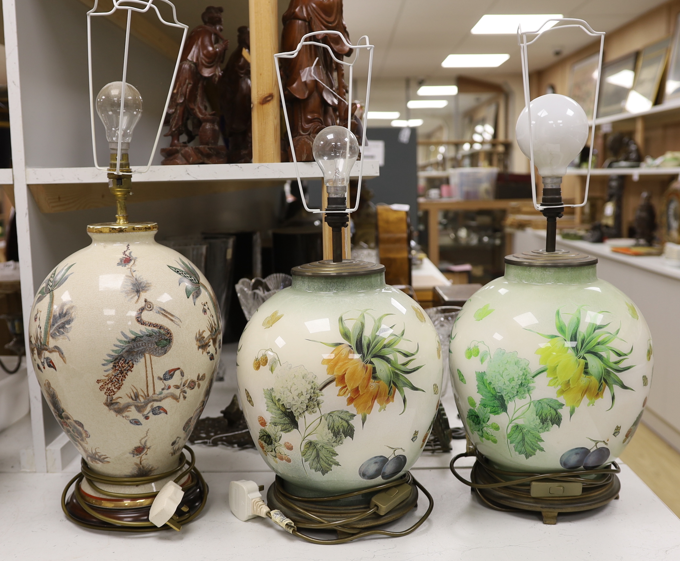 A pair of floral reverse decorated glass decorative table lamps and a similar crackle ware table lamp, 40cm not including light fitting